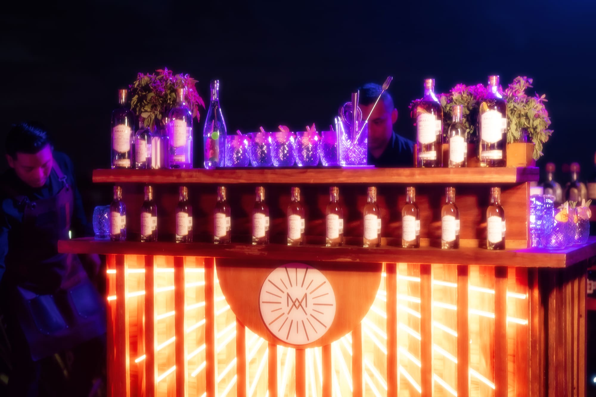 a bar with bottles and flowers on it