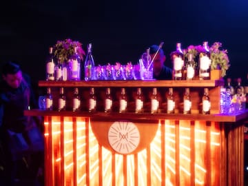 a bar with bottles and flowers on it