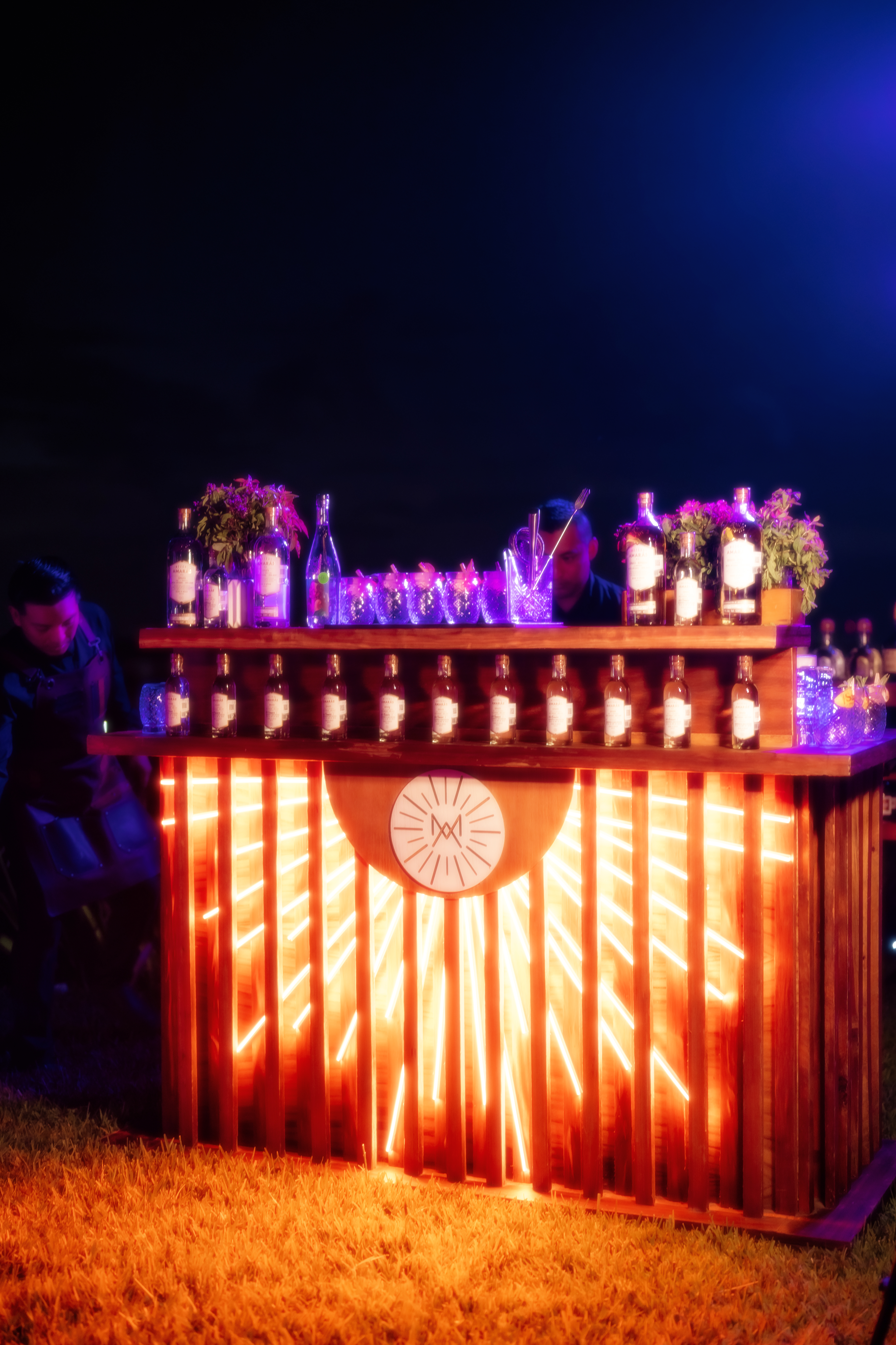 a bar with bottles and flowers on it