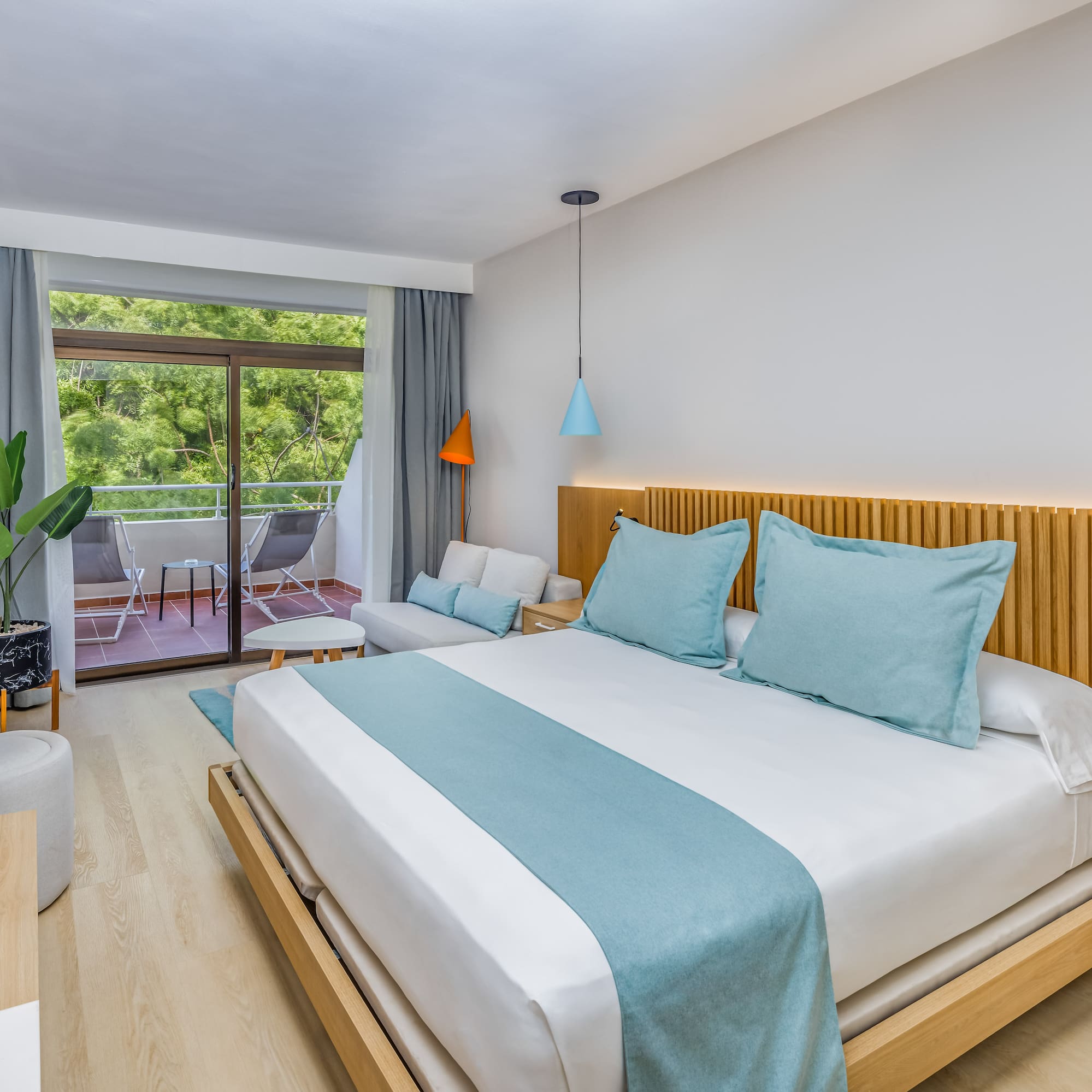 a bedroom with a bed and a plant