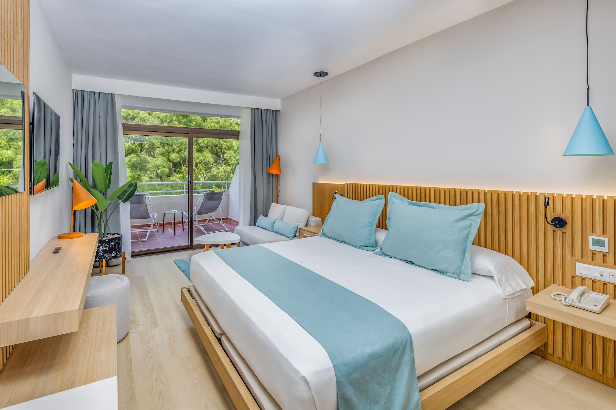 a bedroom with a bed and a plant