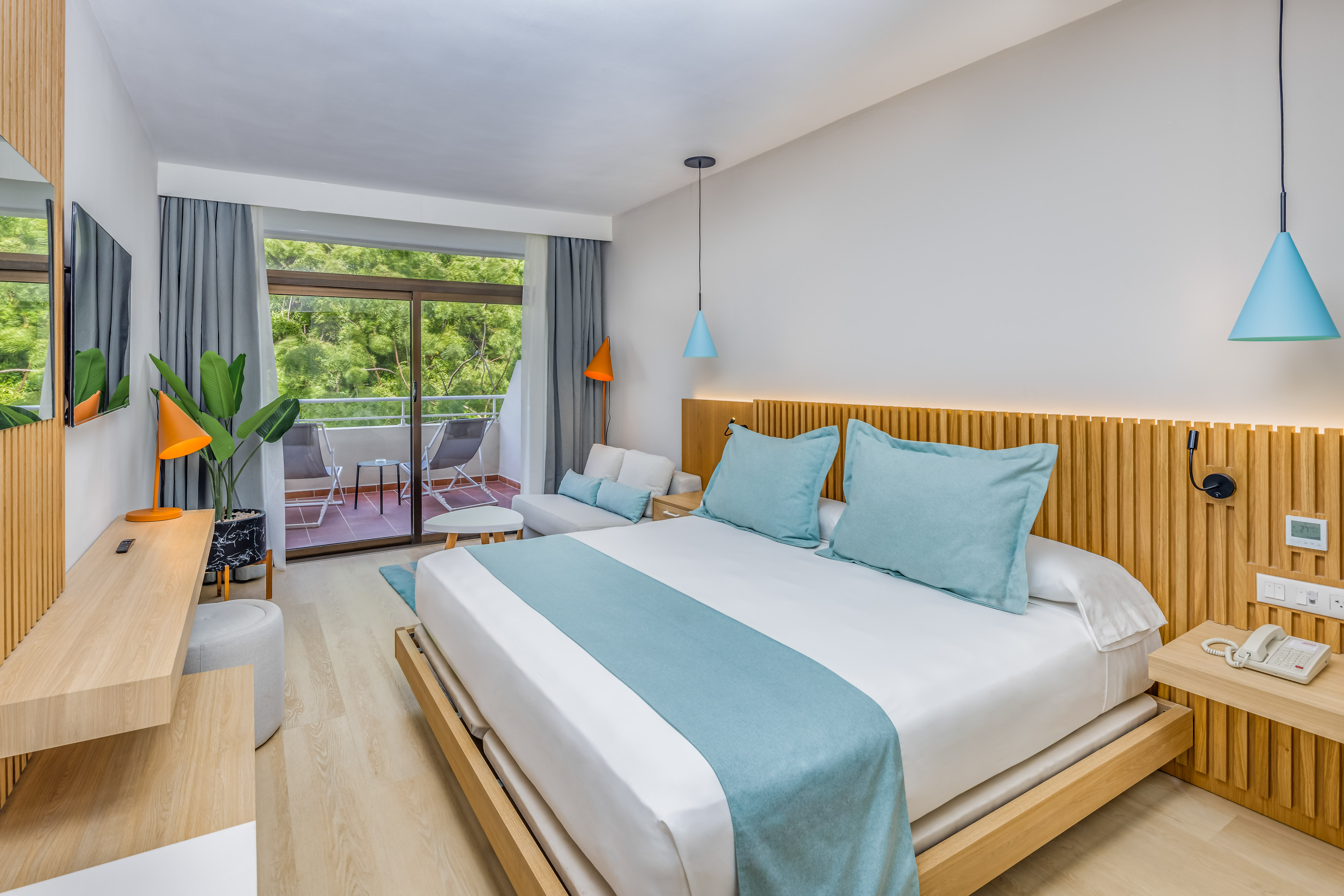 a bedroom with a bed and a plant