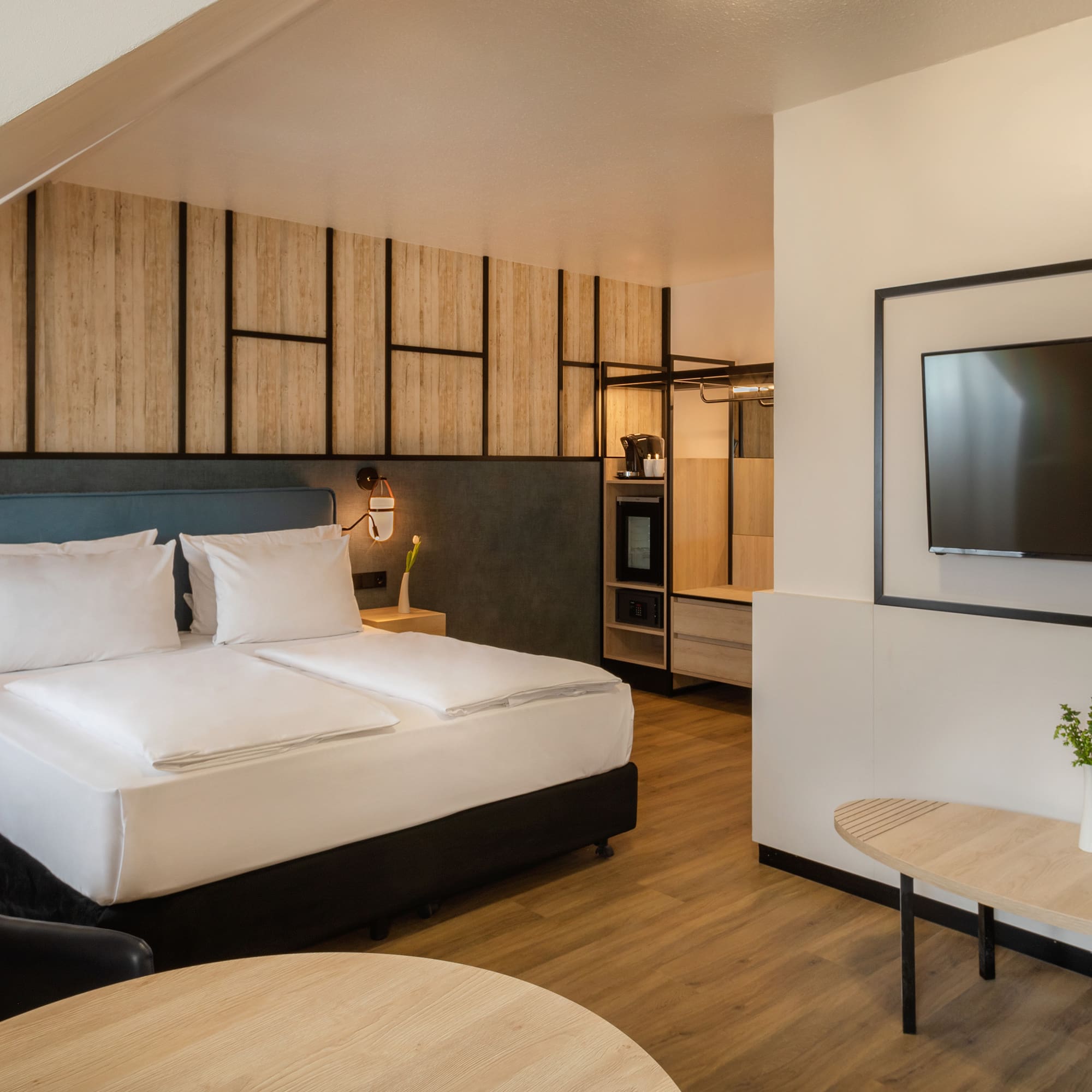 a room with a bed and a television