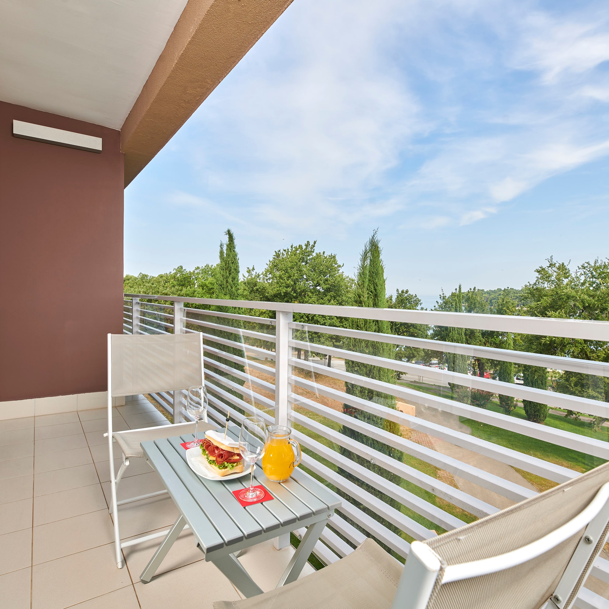 a table and chairs on a balcony