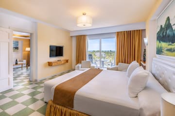 a room with a large bed and a television