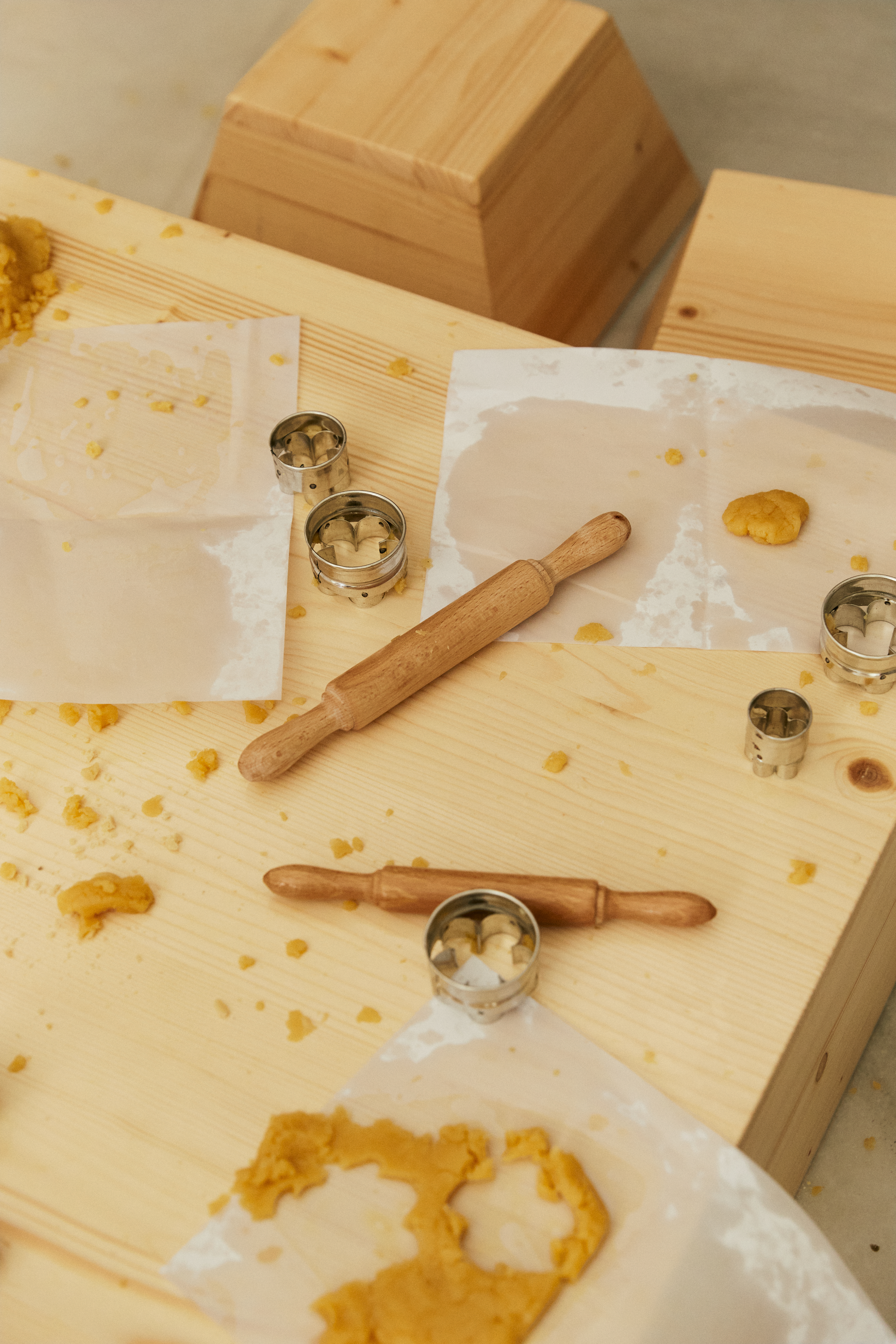a rolling pin and cookie cutters on a table