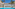 Luxury resort with large swimming pool, palm trees, and Mediterranean architecture.