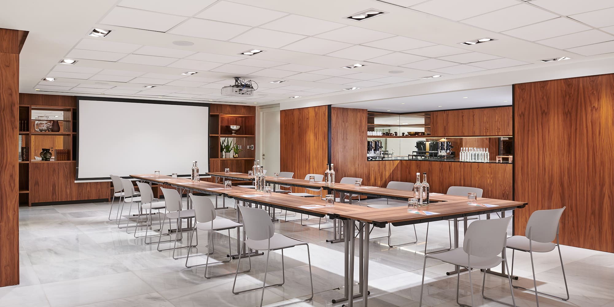 a room with long tables and chairs