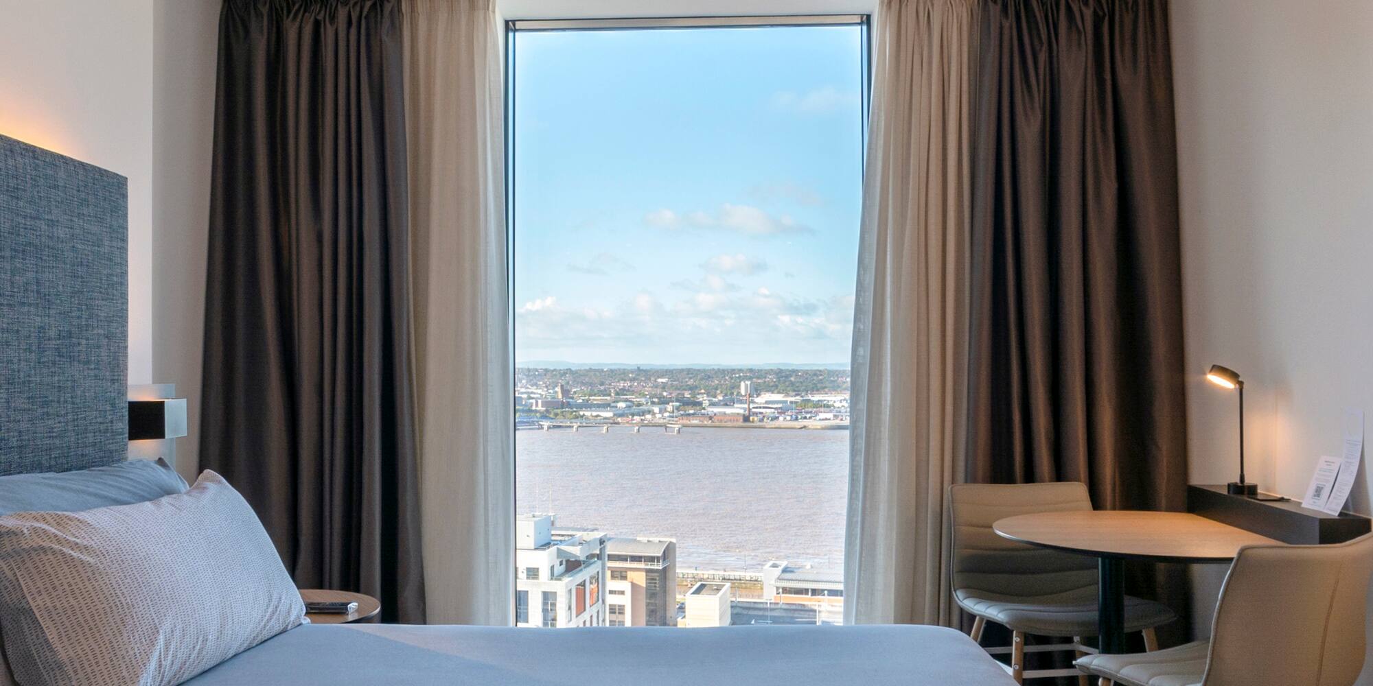 a room with a view of a city and a river
