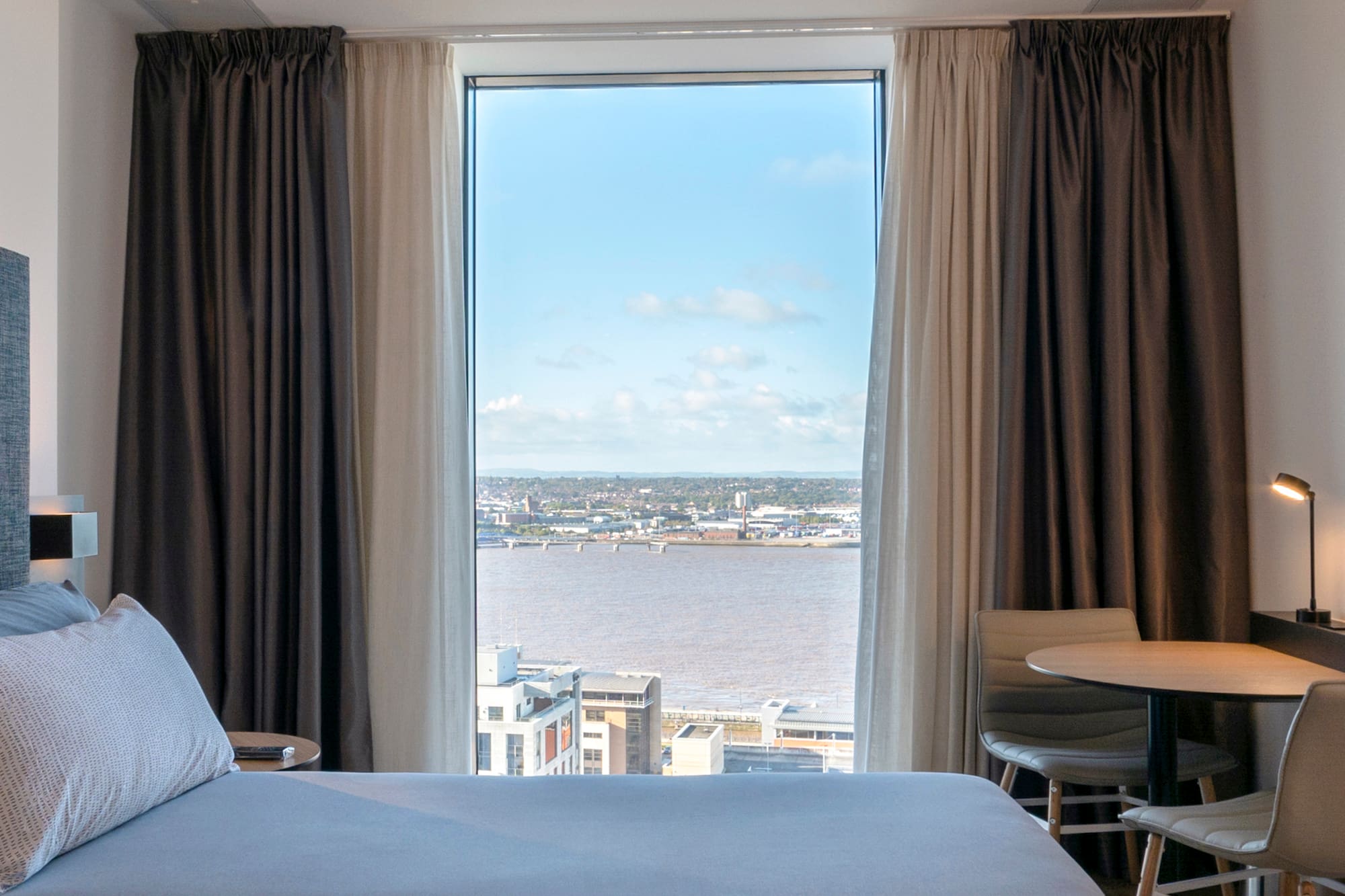 a room with a view of a city and a river