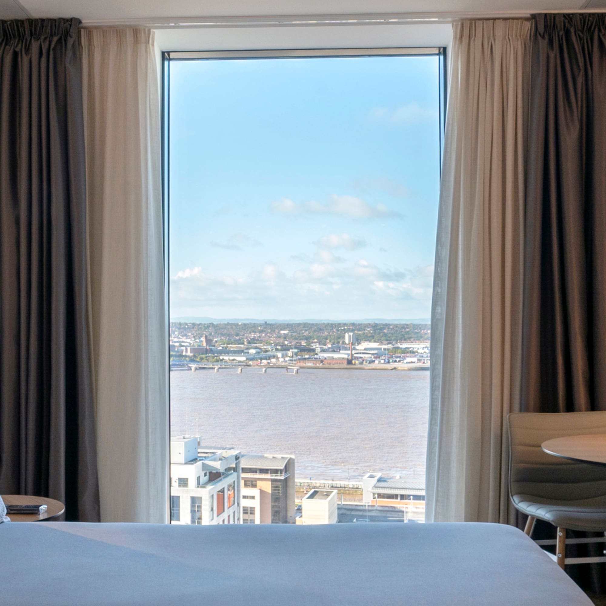 a room with a view of a city and a river