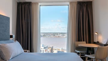 a room with a view of a city and a river