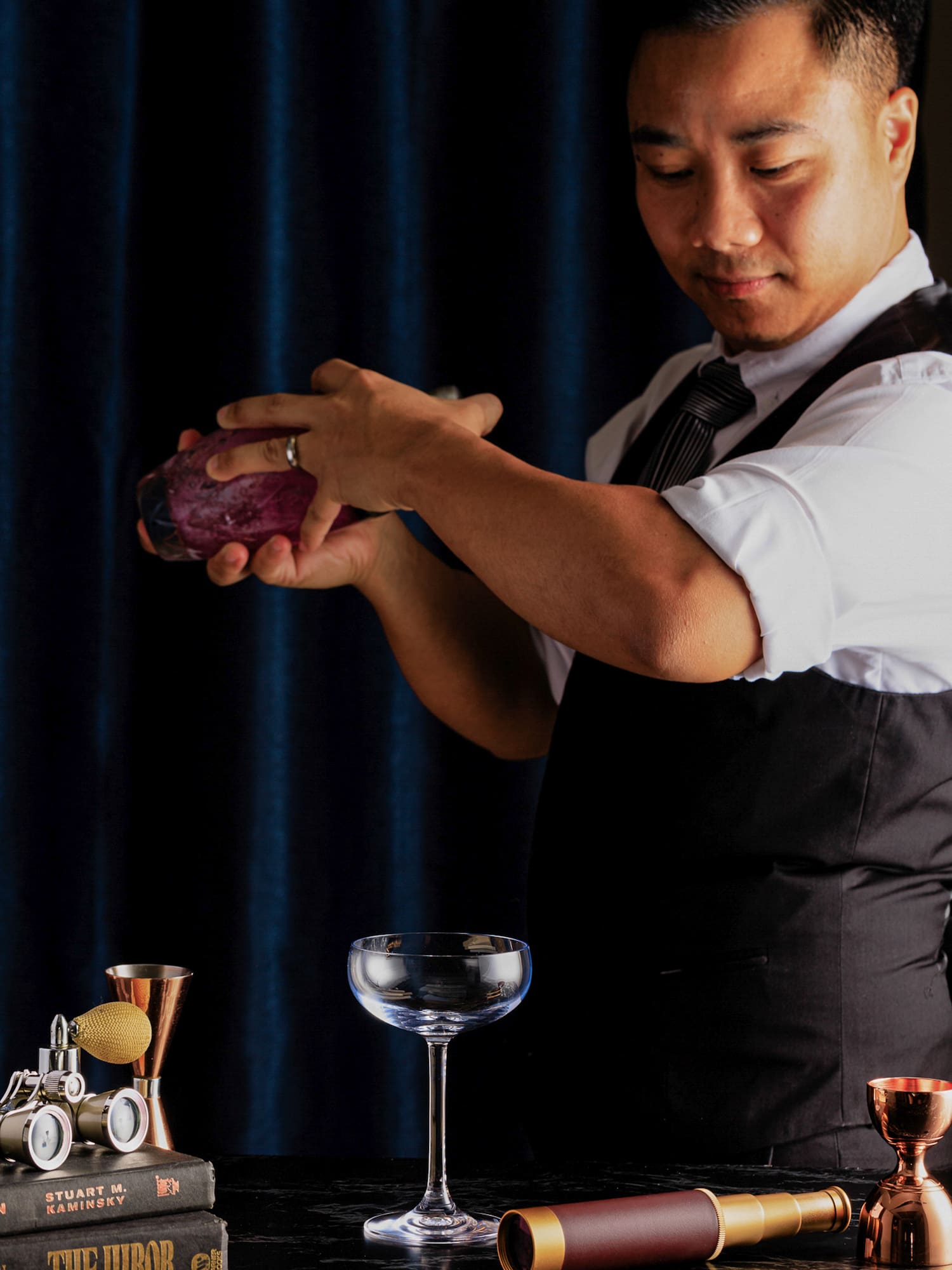a man holding a purple shaker