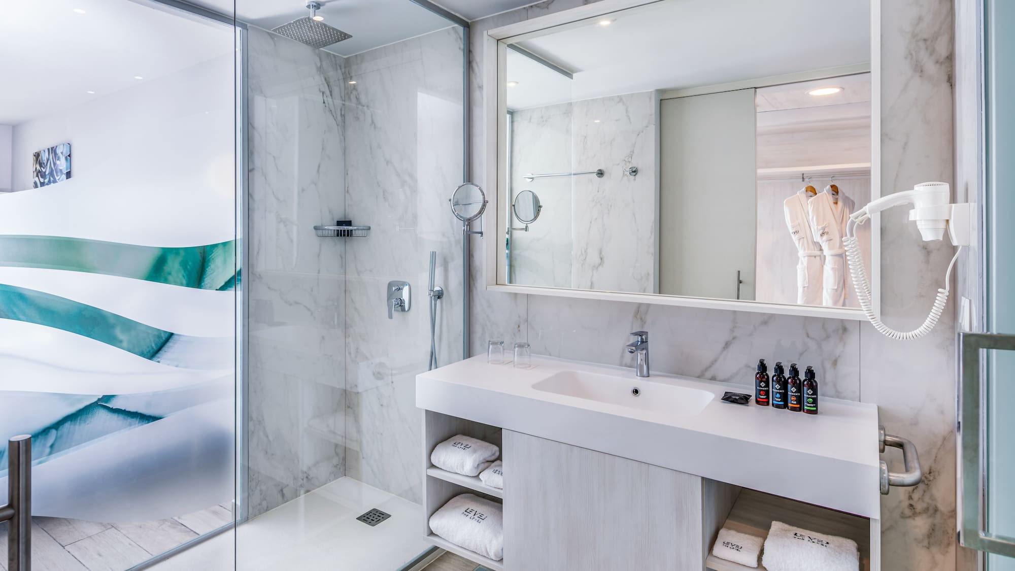 a bathroom with a glass shower and sink