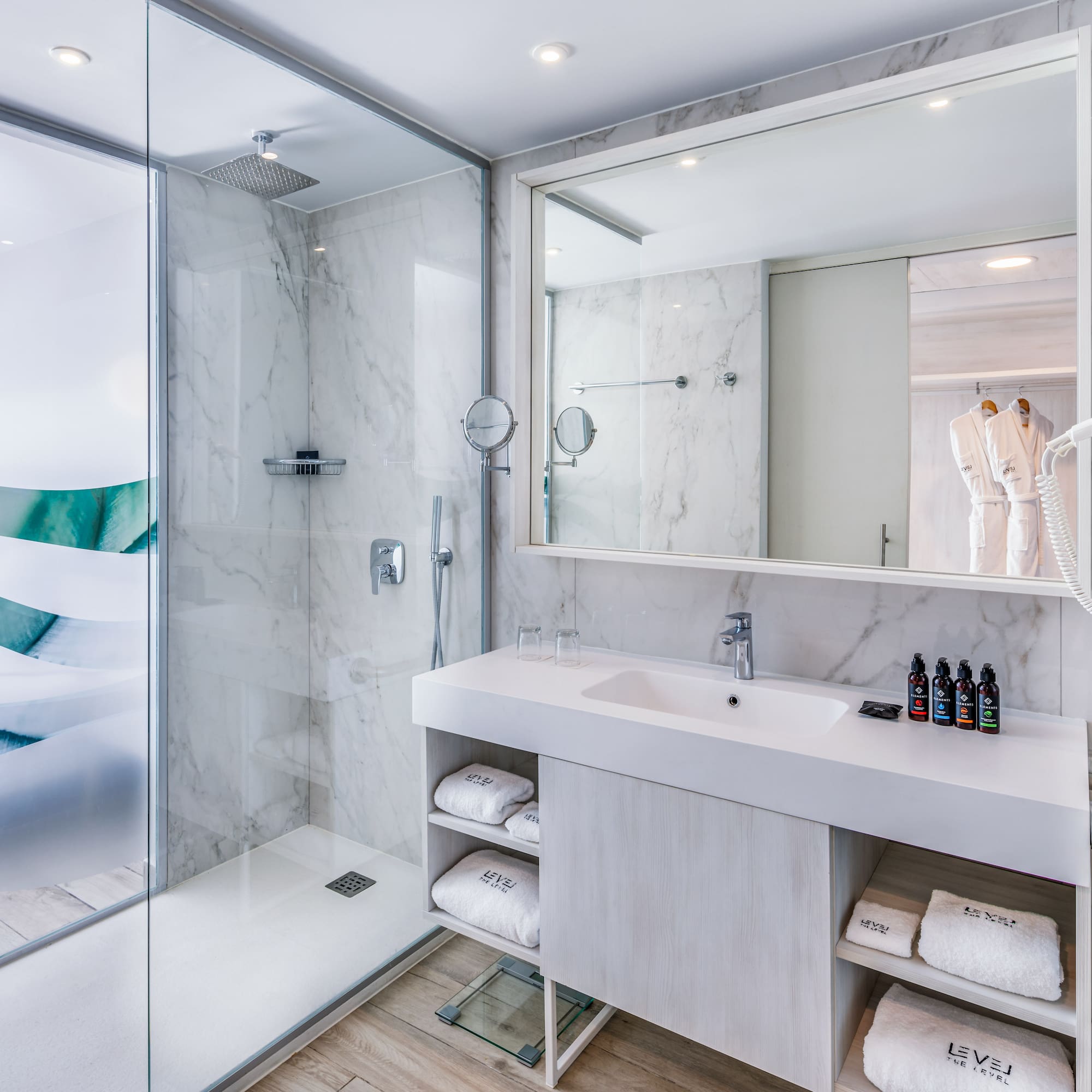 a bathroom with a glass shower and sink