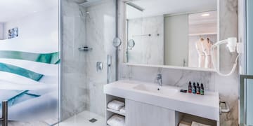 a bathroom with a glass shower and sink