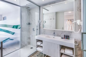 a bathroom with a glass shower and sink