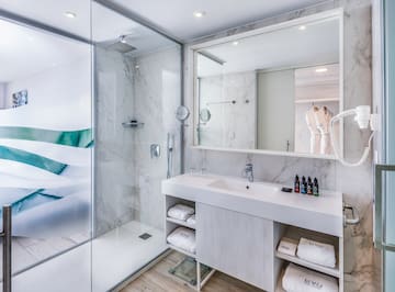 a bathroom with a glass shower and sink