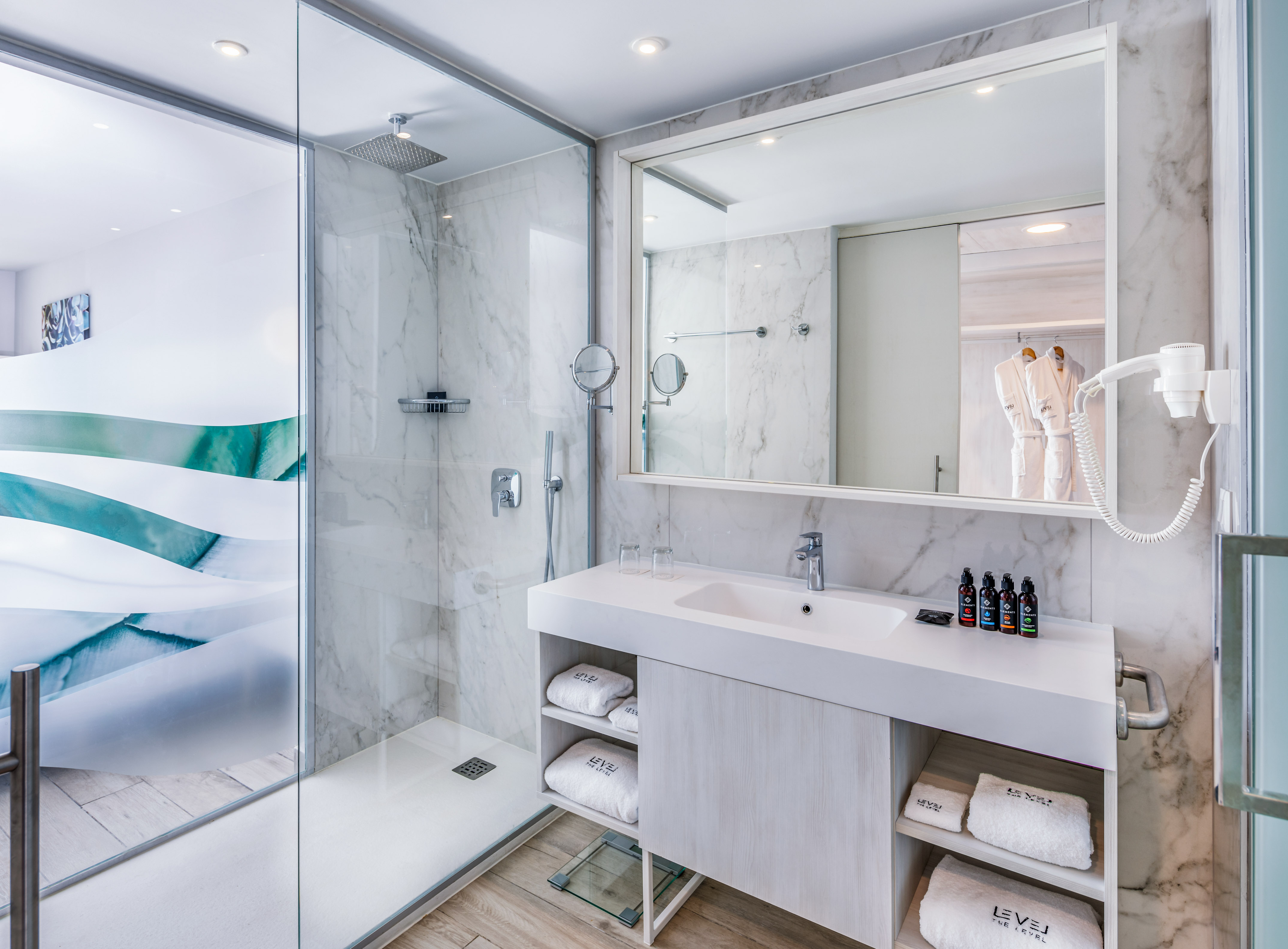 a bathroom with a glass shower and sink