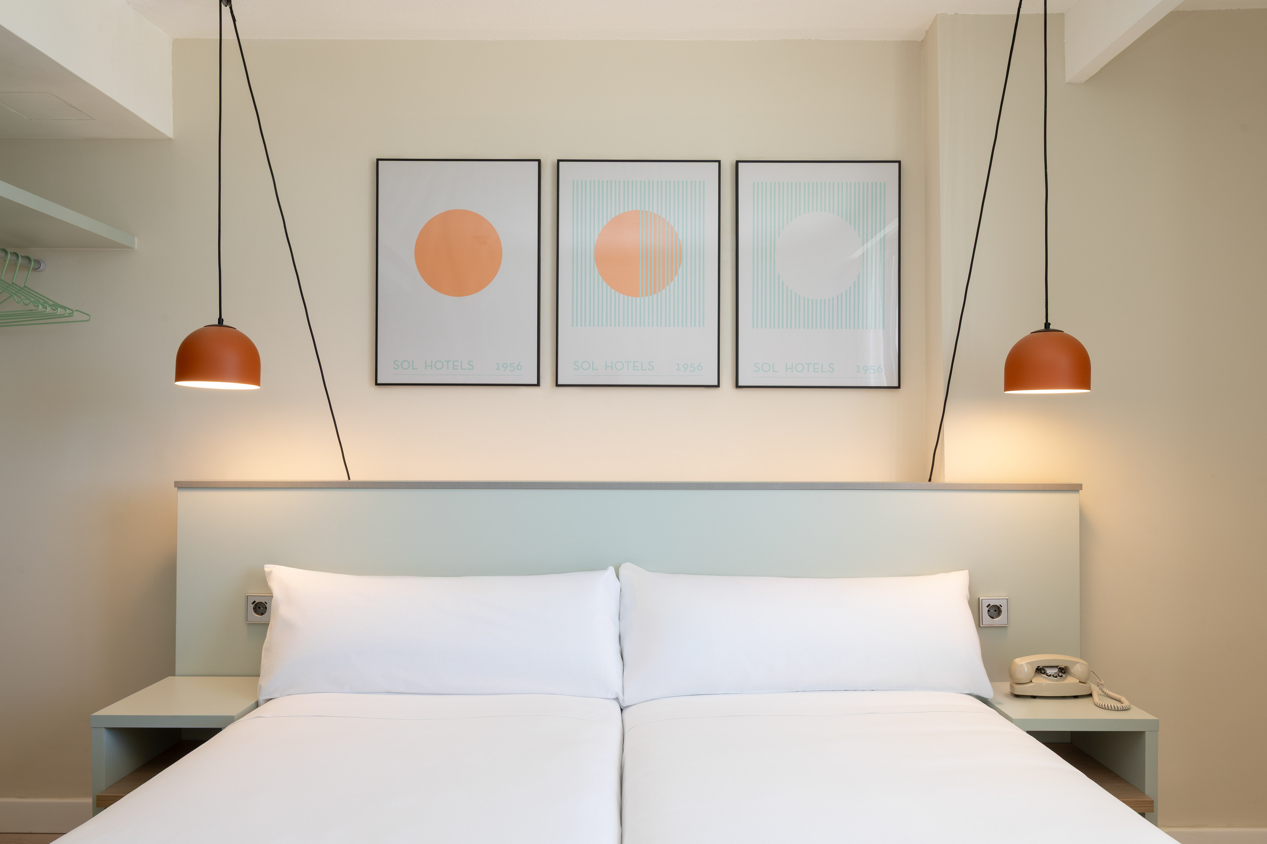 a bed with two lamps above it