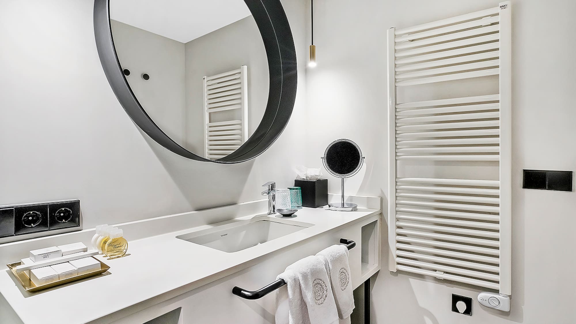 a bathroom with a round mirror