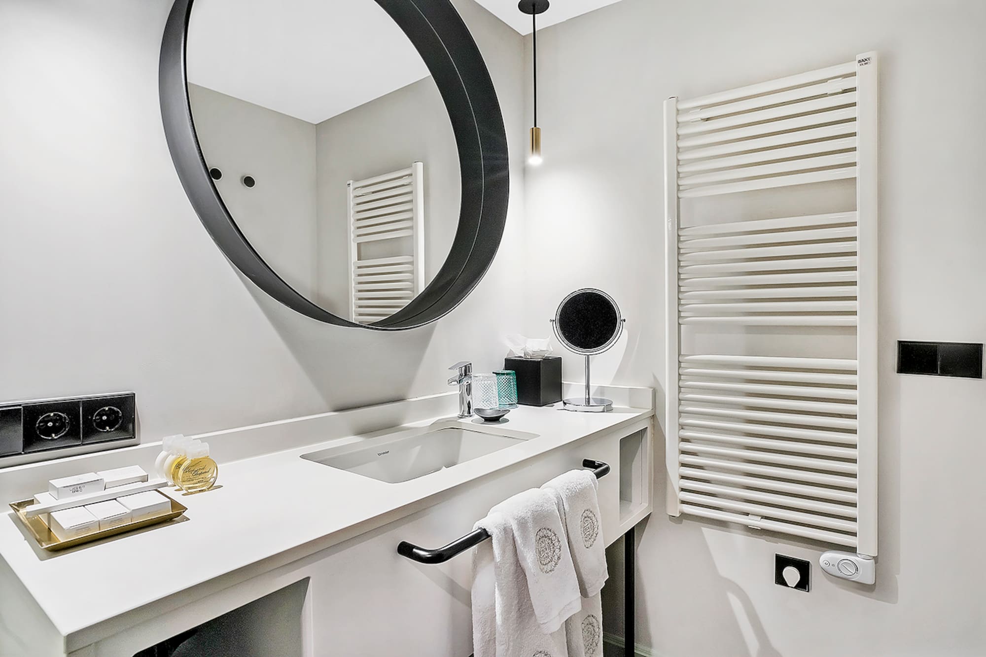 a bathroom with a round mirror