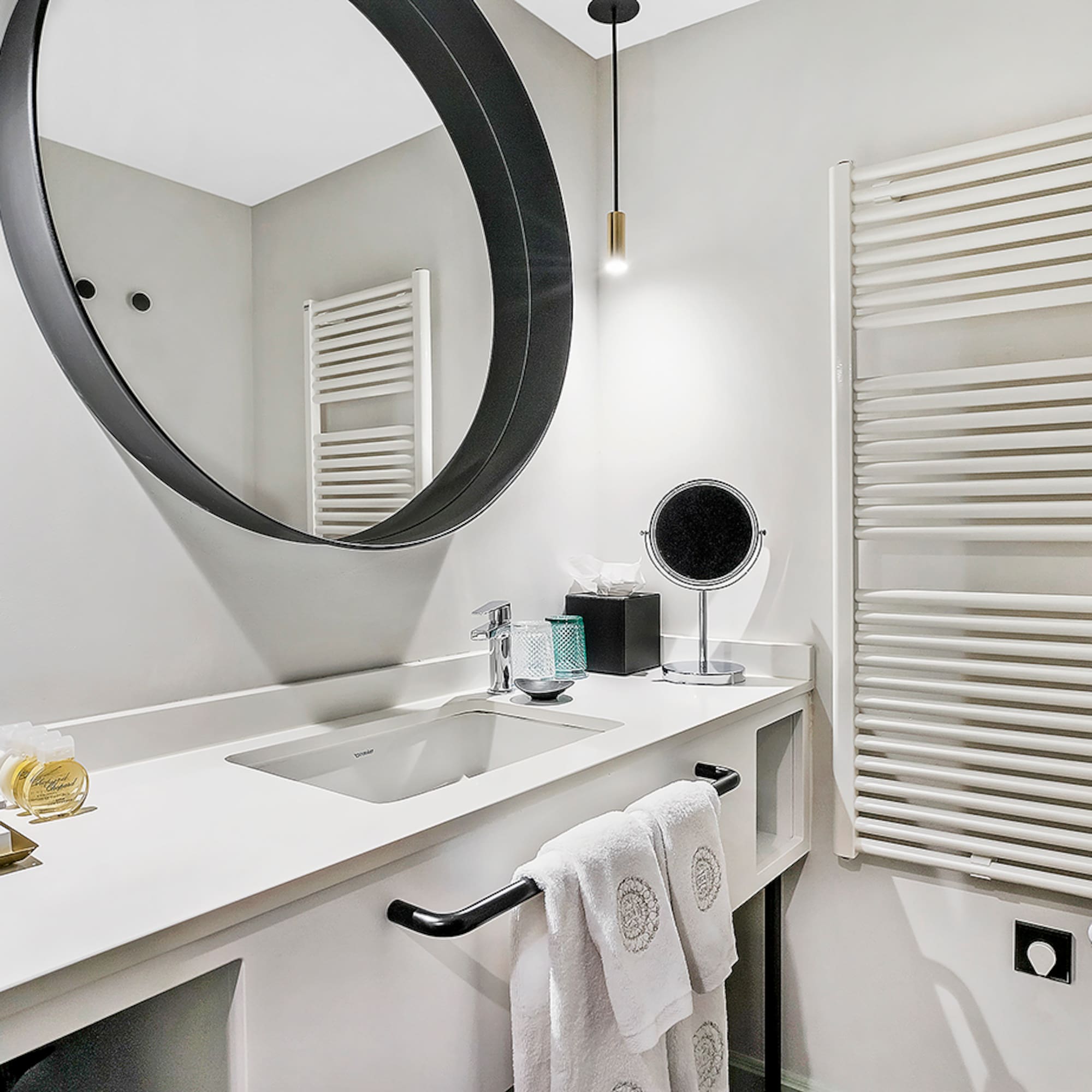 a bathroom with a round mirror
