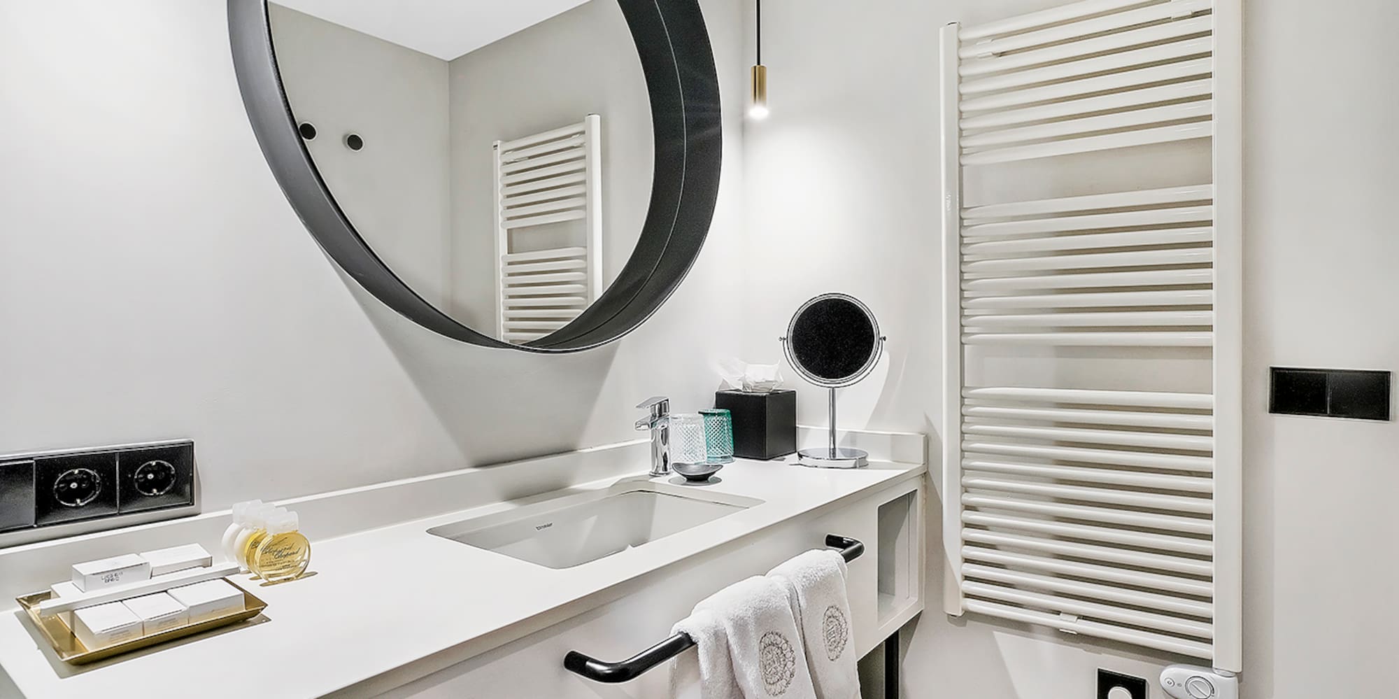a bathroom with a round mirror
