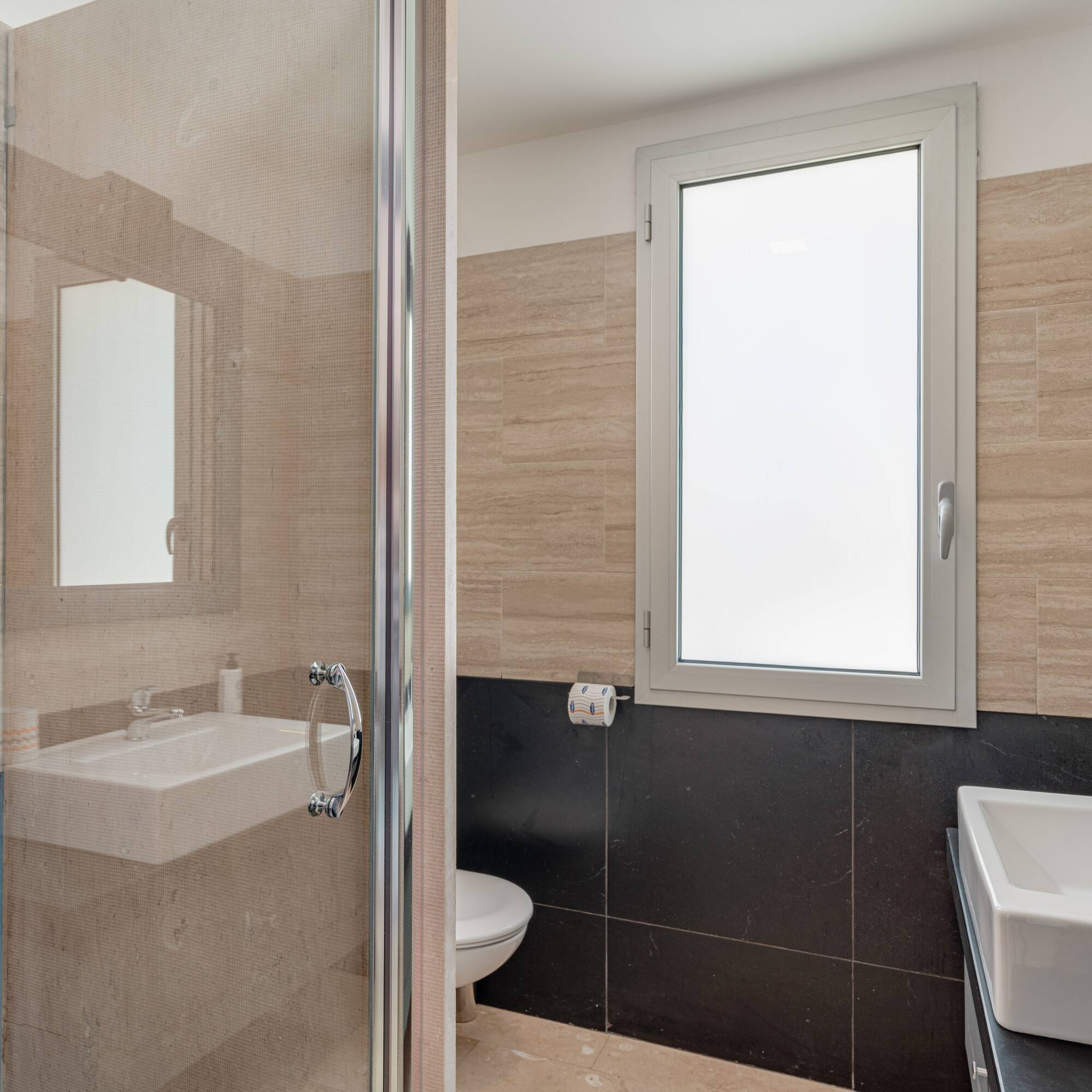 a bathroom with a glass shower door
