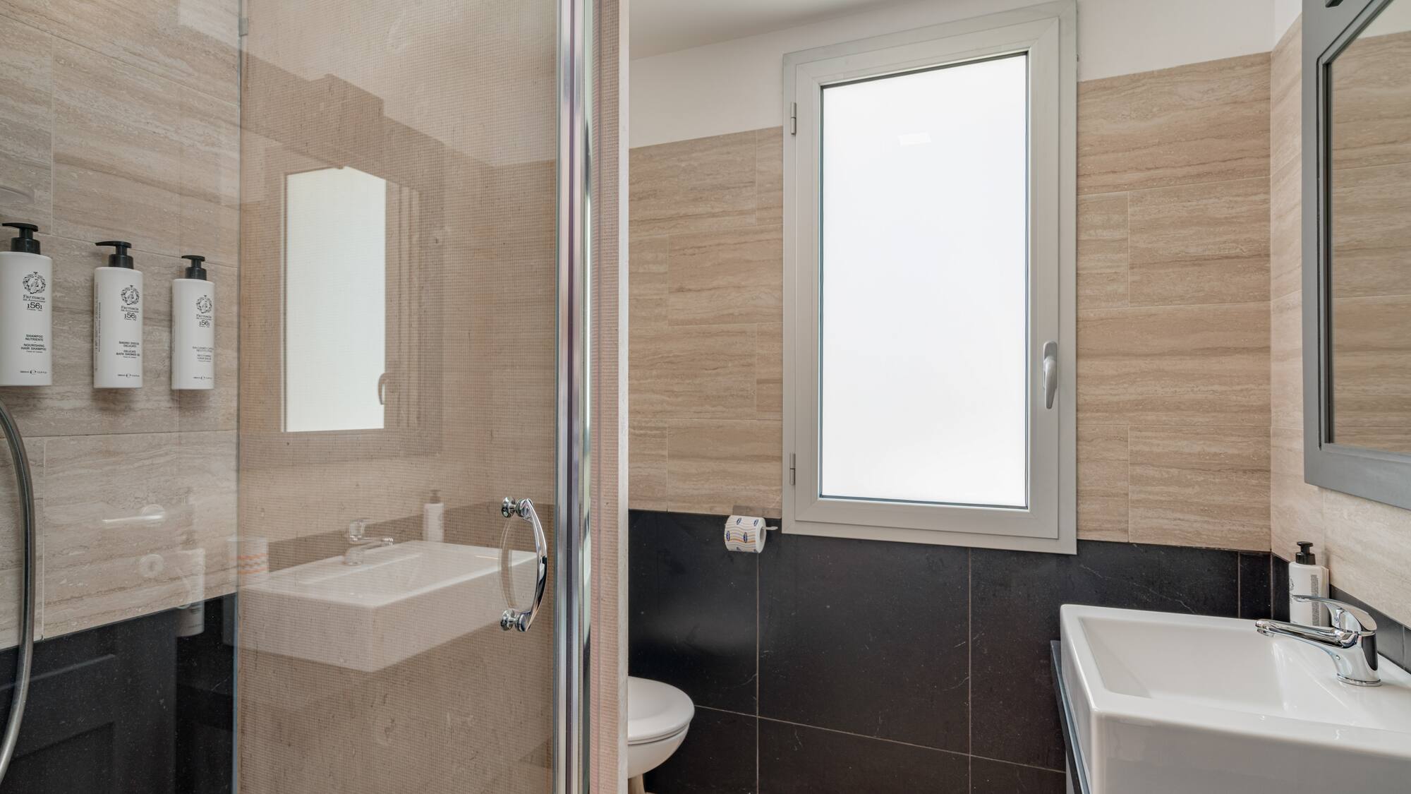 a bathroom with a glass shower door