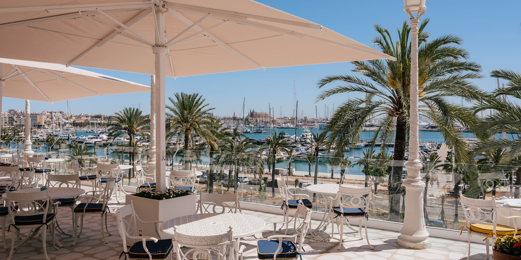 a patio with tables and chairs and umbrellas