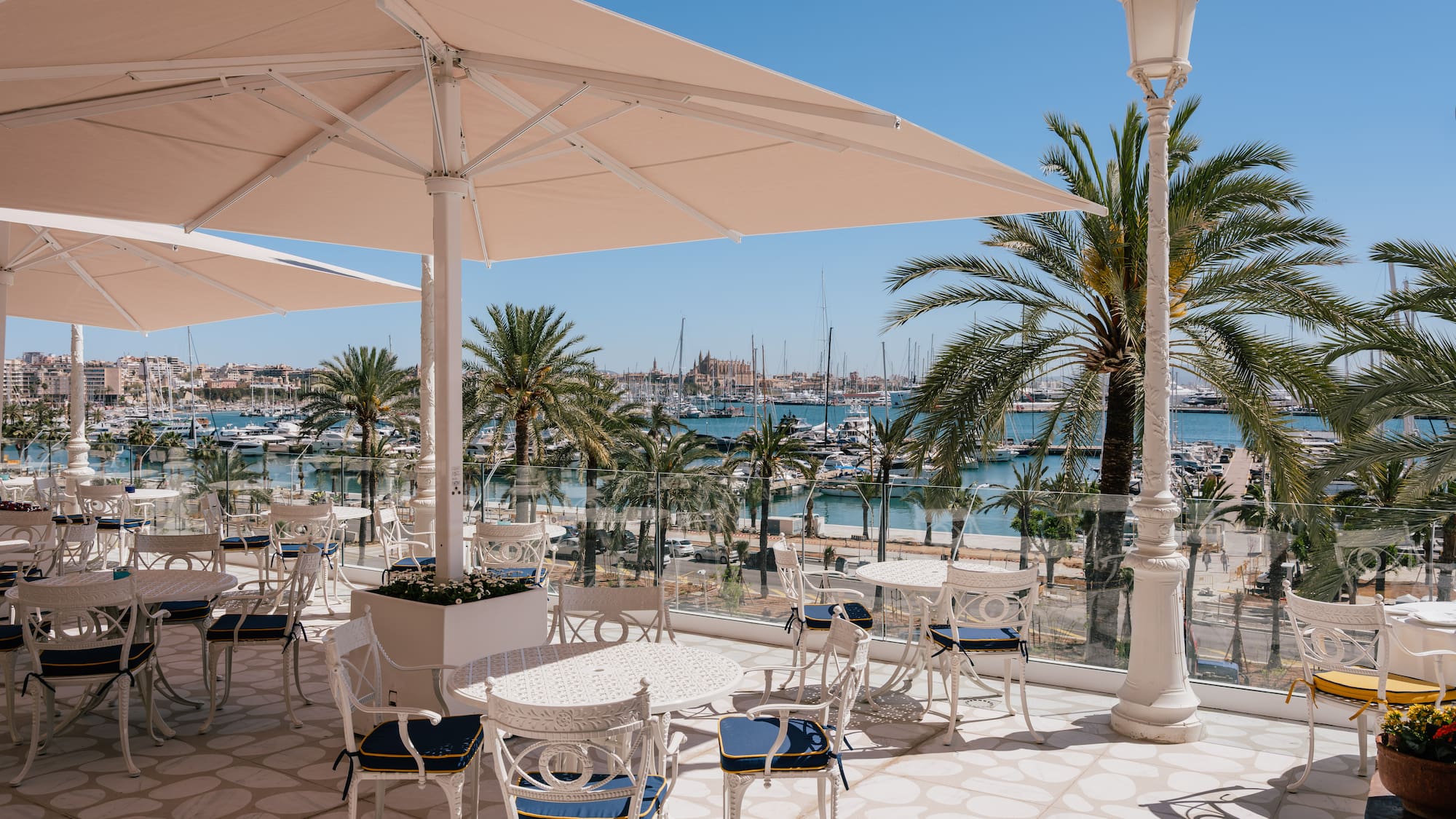 a patio with tables and chairs and umbrellas