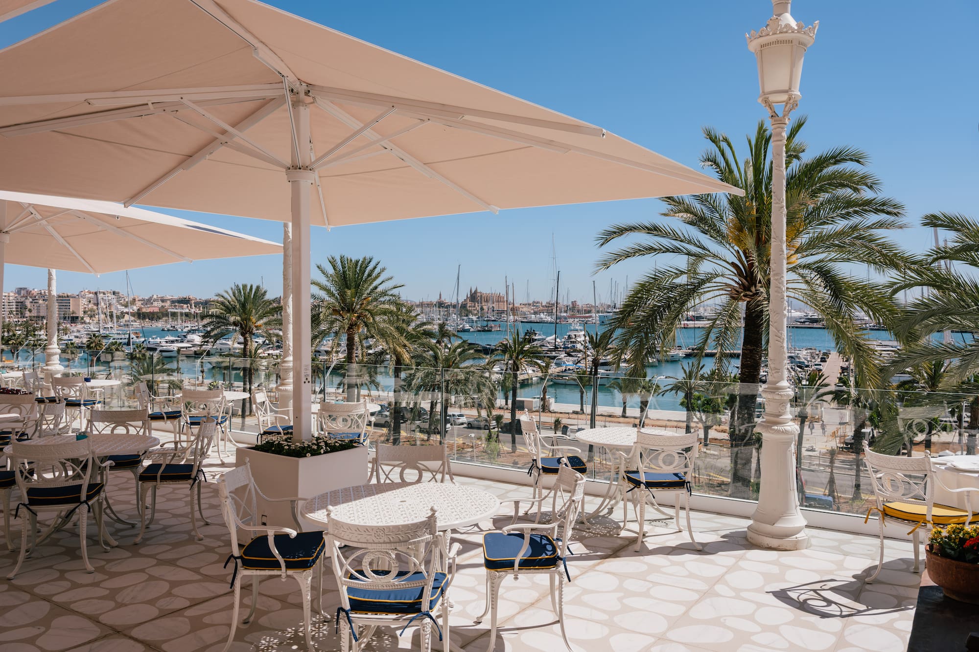 a patio with tables and chairs and umbrellas
