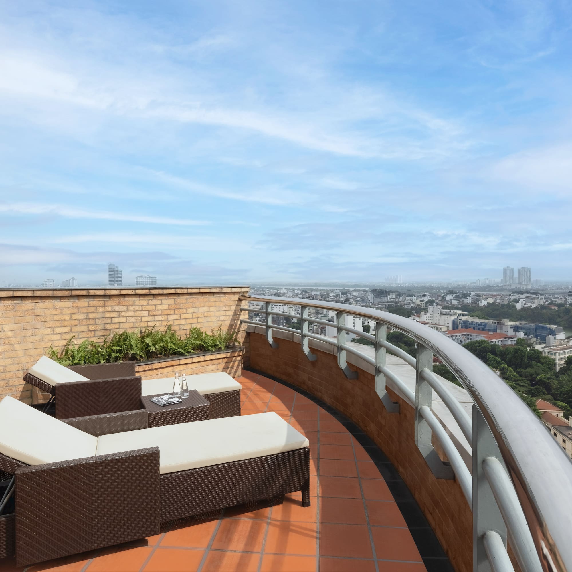 a deck with chairs and a view of a city