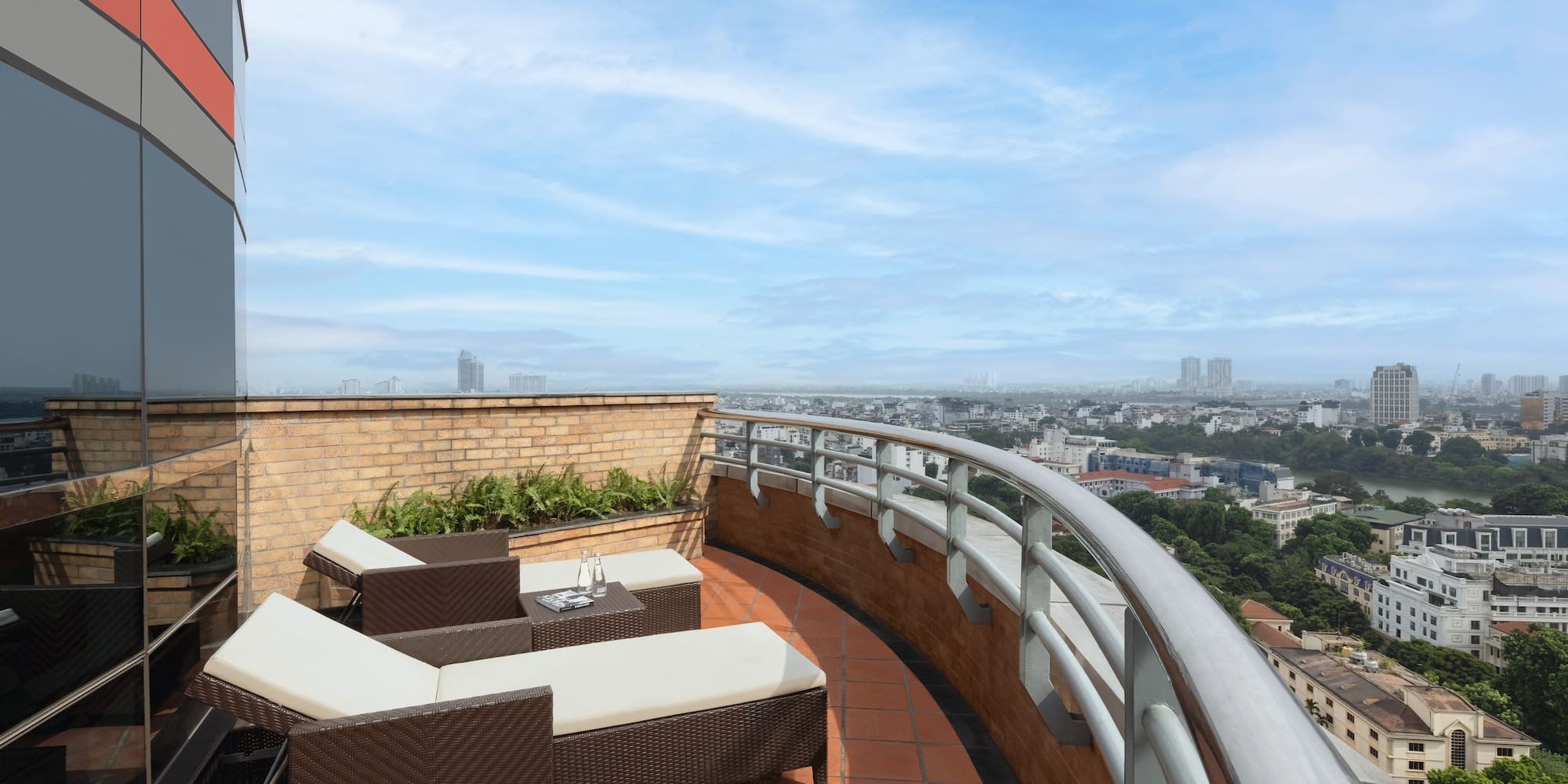 a deck with chairs and a view of a city