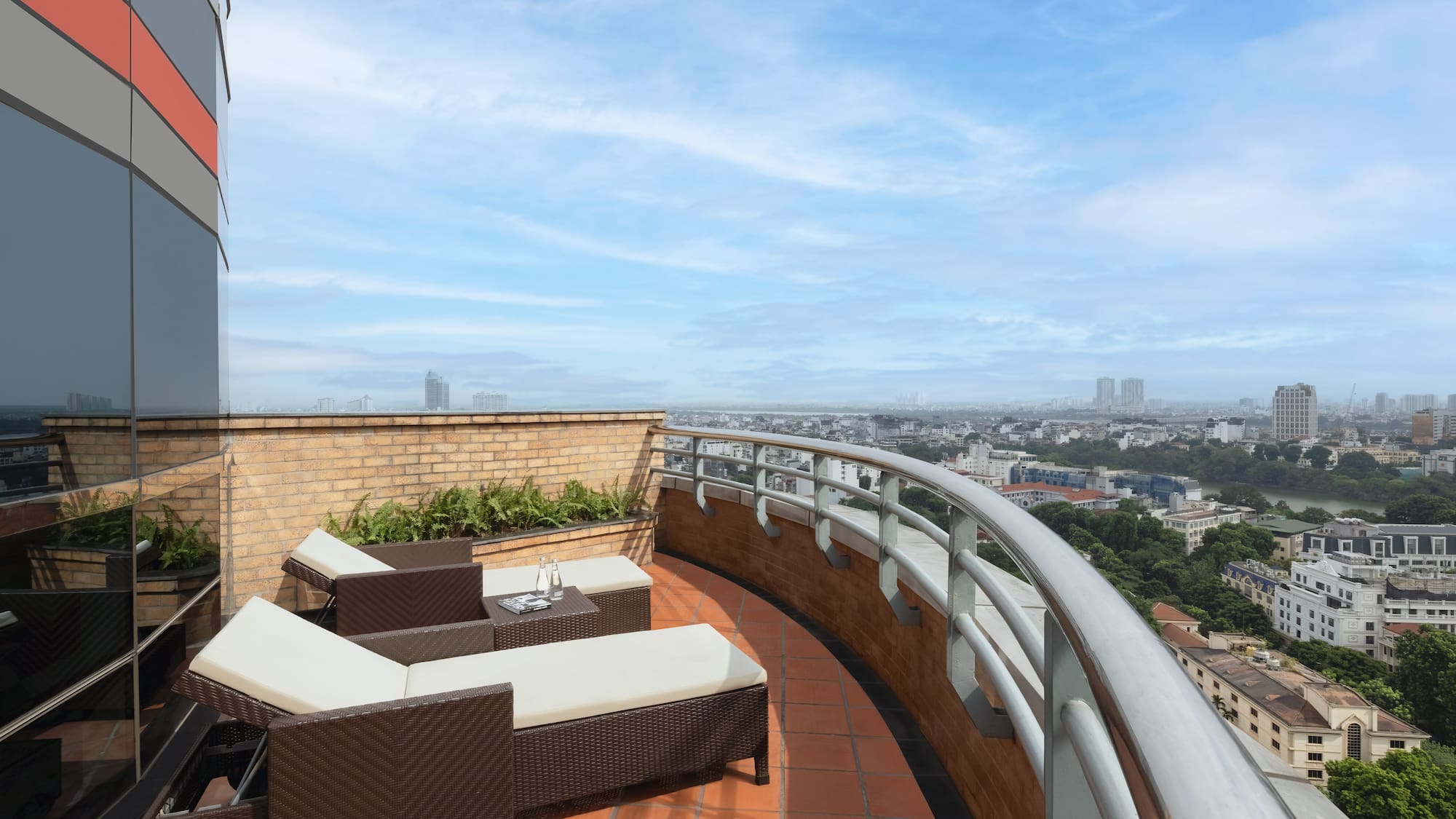 a deck with chairs and a view of a city