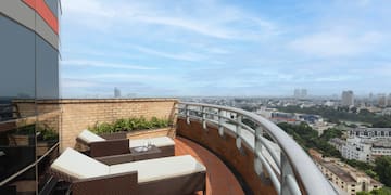 a deck with chairs and a view of a city