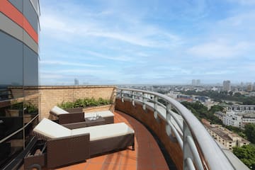 a deck with chairs and a view of a city