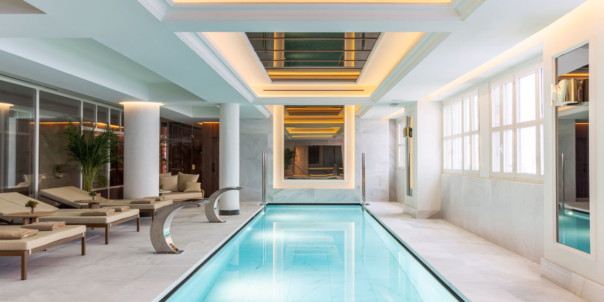 a indoor swimming pool with a large rectangular pool