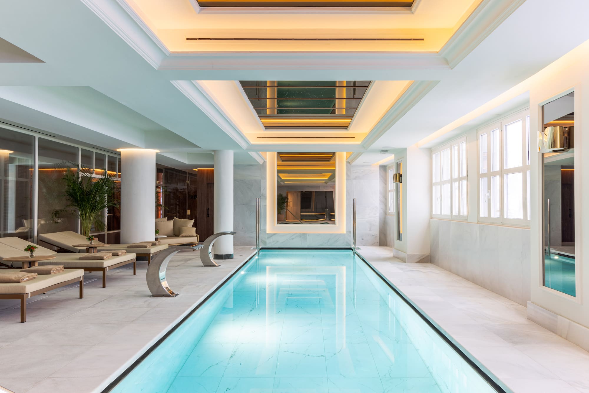 a indoor swimming pool with a large rectangular pool
