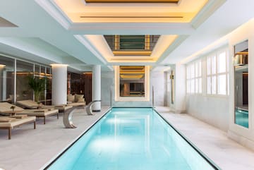 a indoor swimming pool with a large rectangular pool
