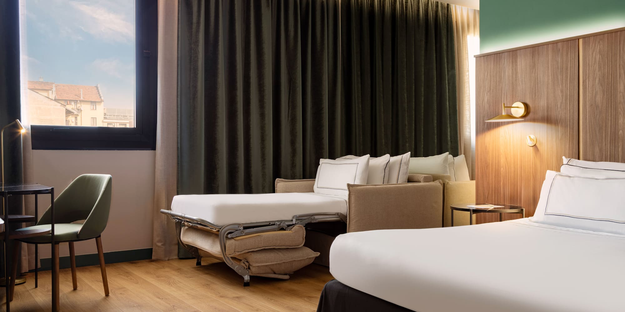 a room with two beds and a chair