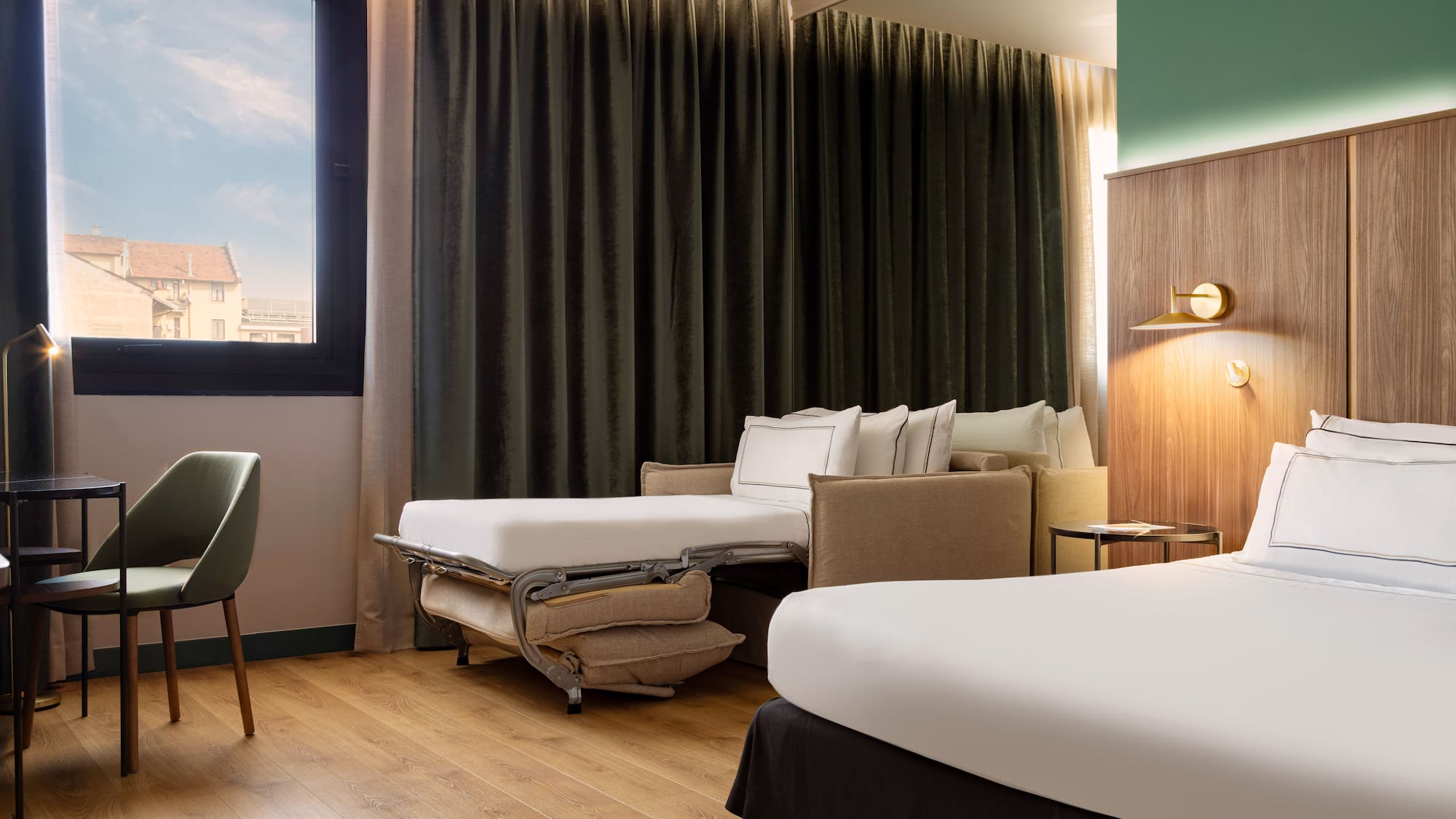 a room with two beds and a chair