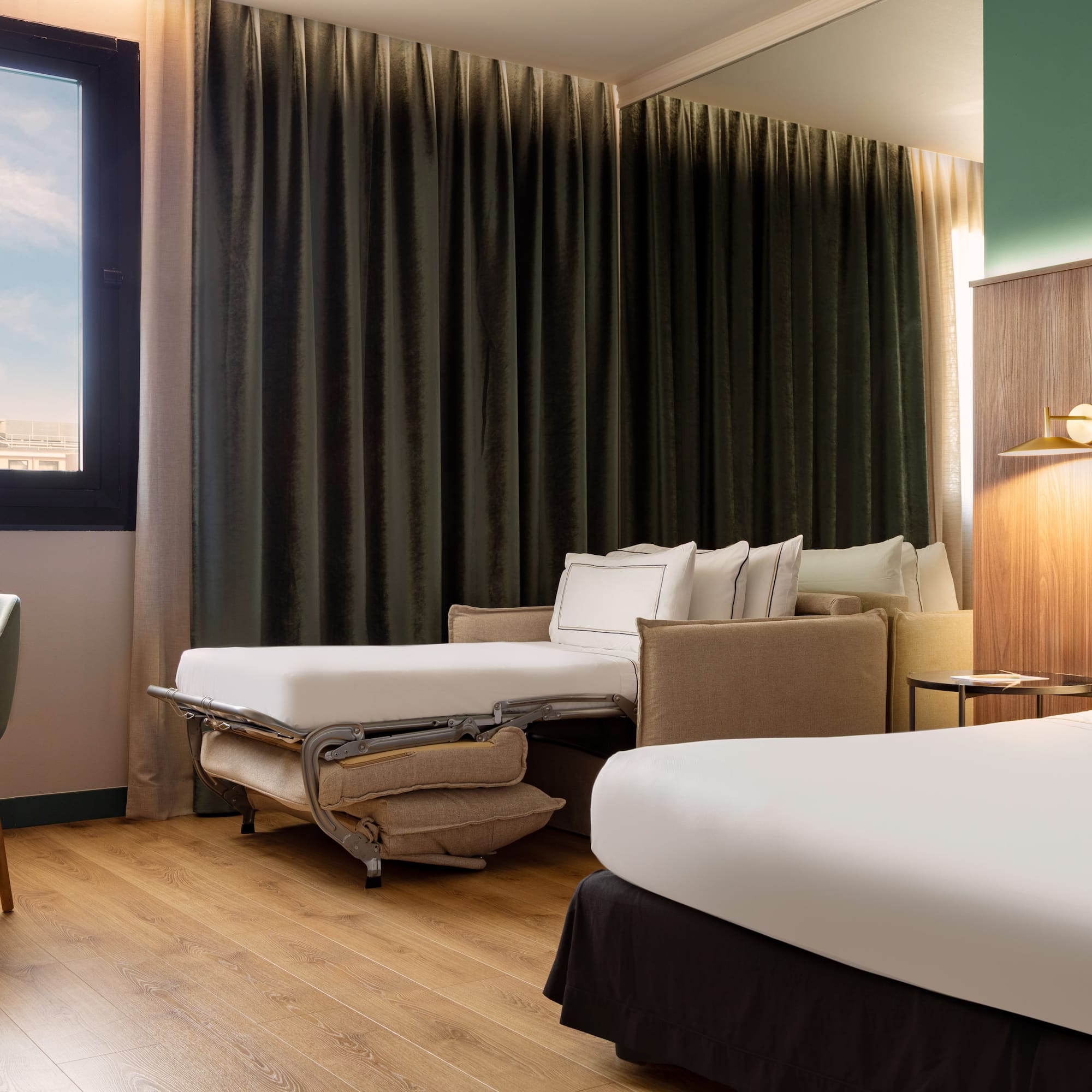 a room with two beds and a chair