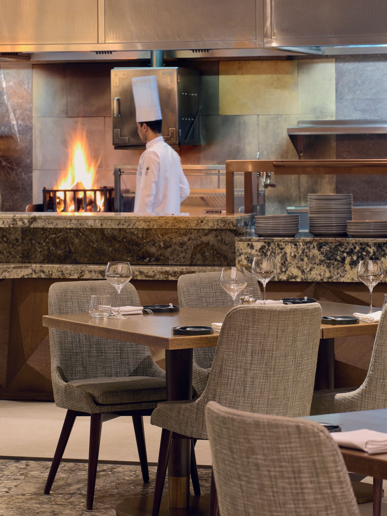 a restaurant with a chef in the background