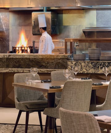 a restaurant with a chef in the background