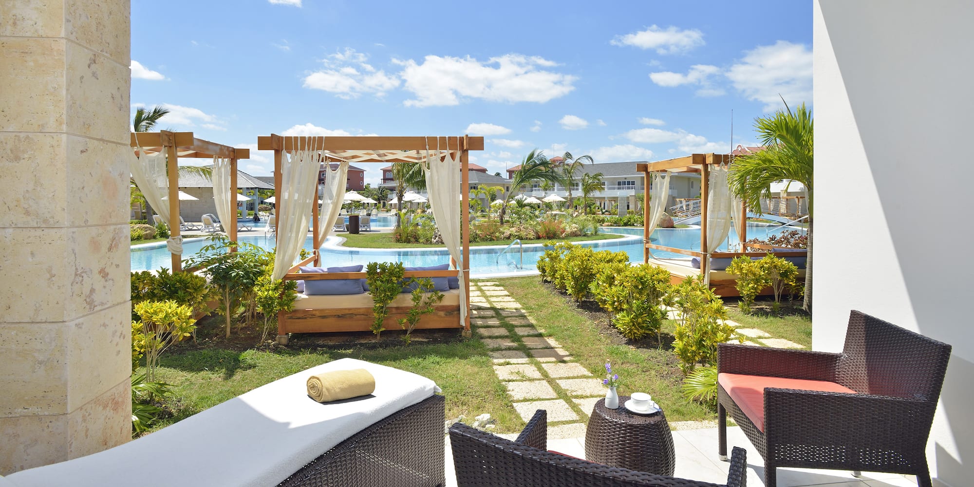 a pool with chairs and a bed