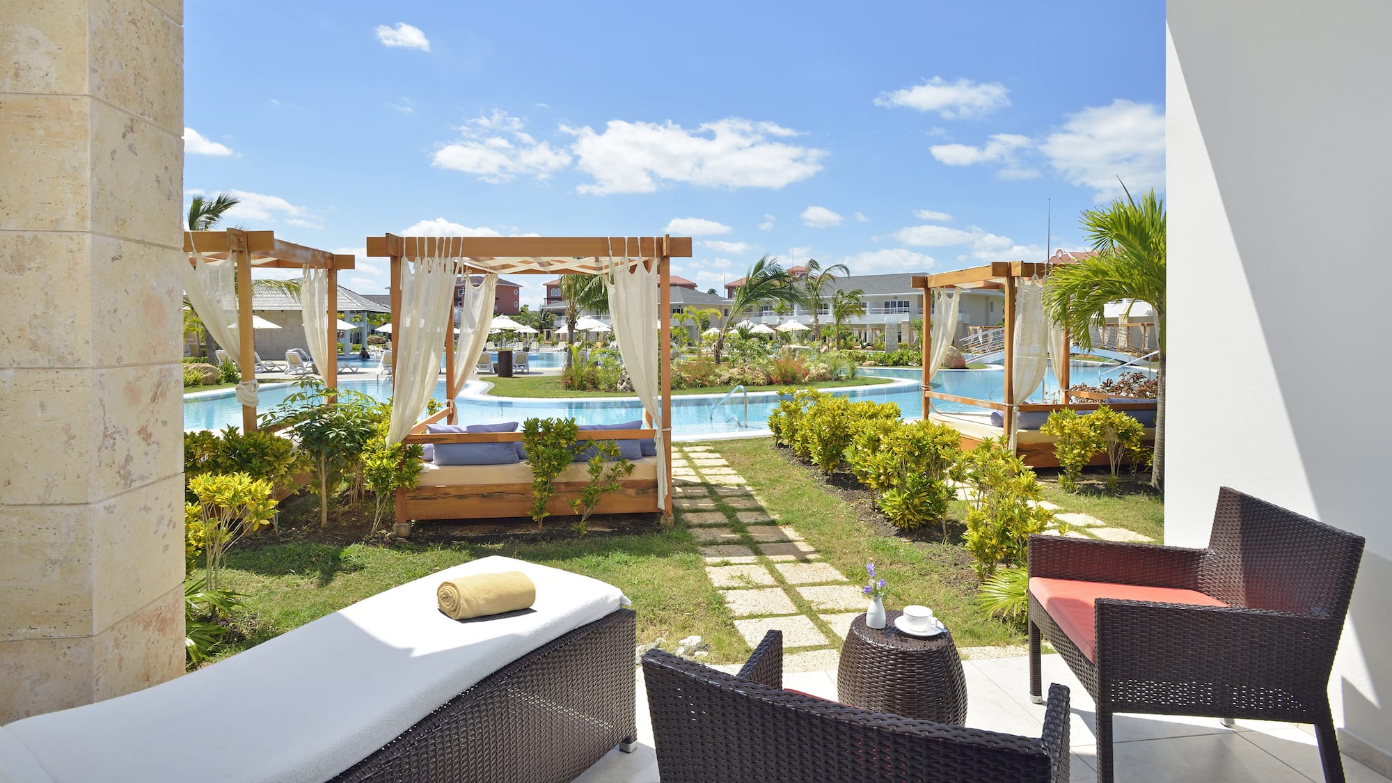 a pool with chairs and a bed