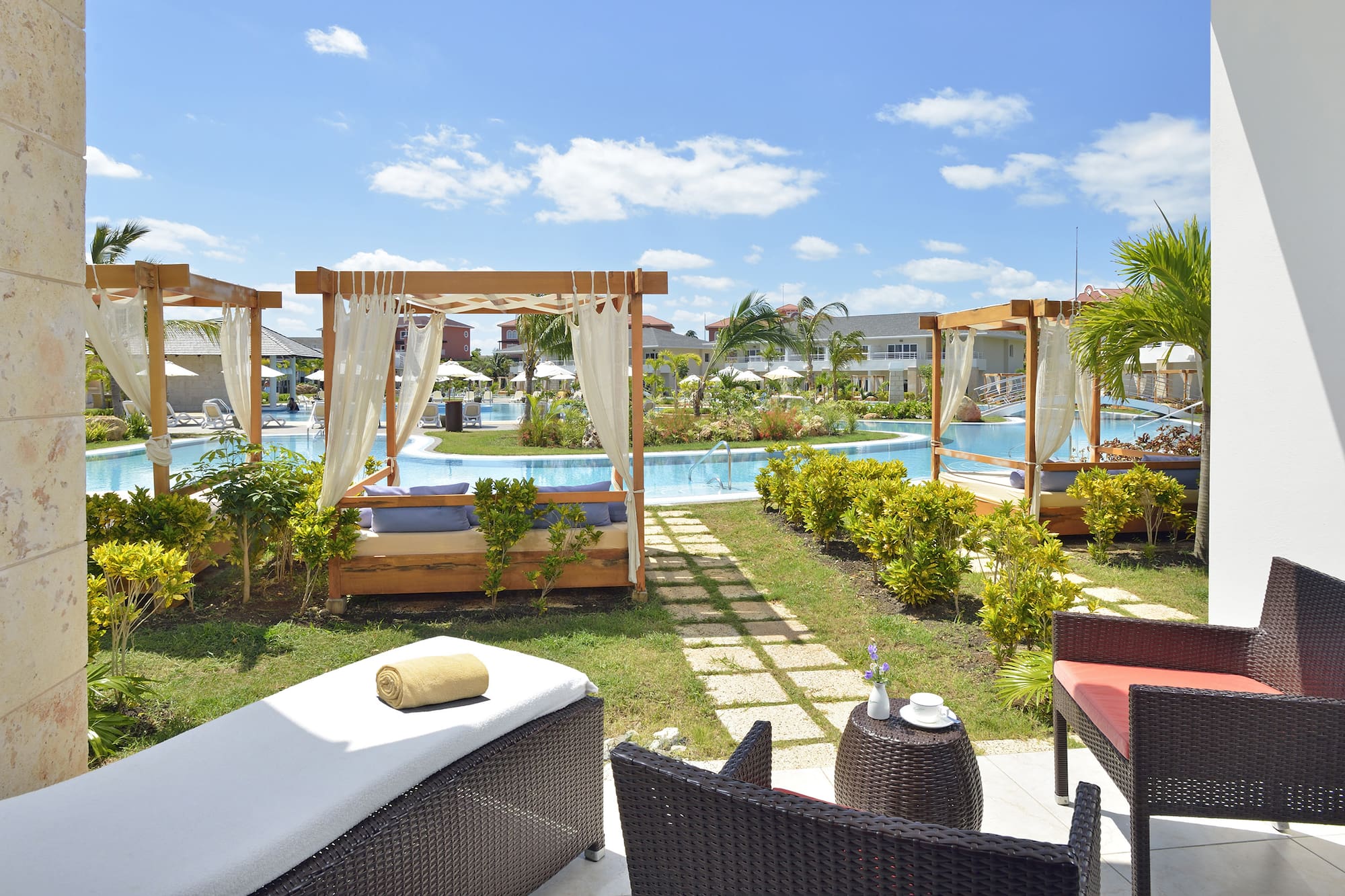 a pool with chairs and a bed