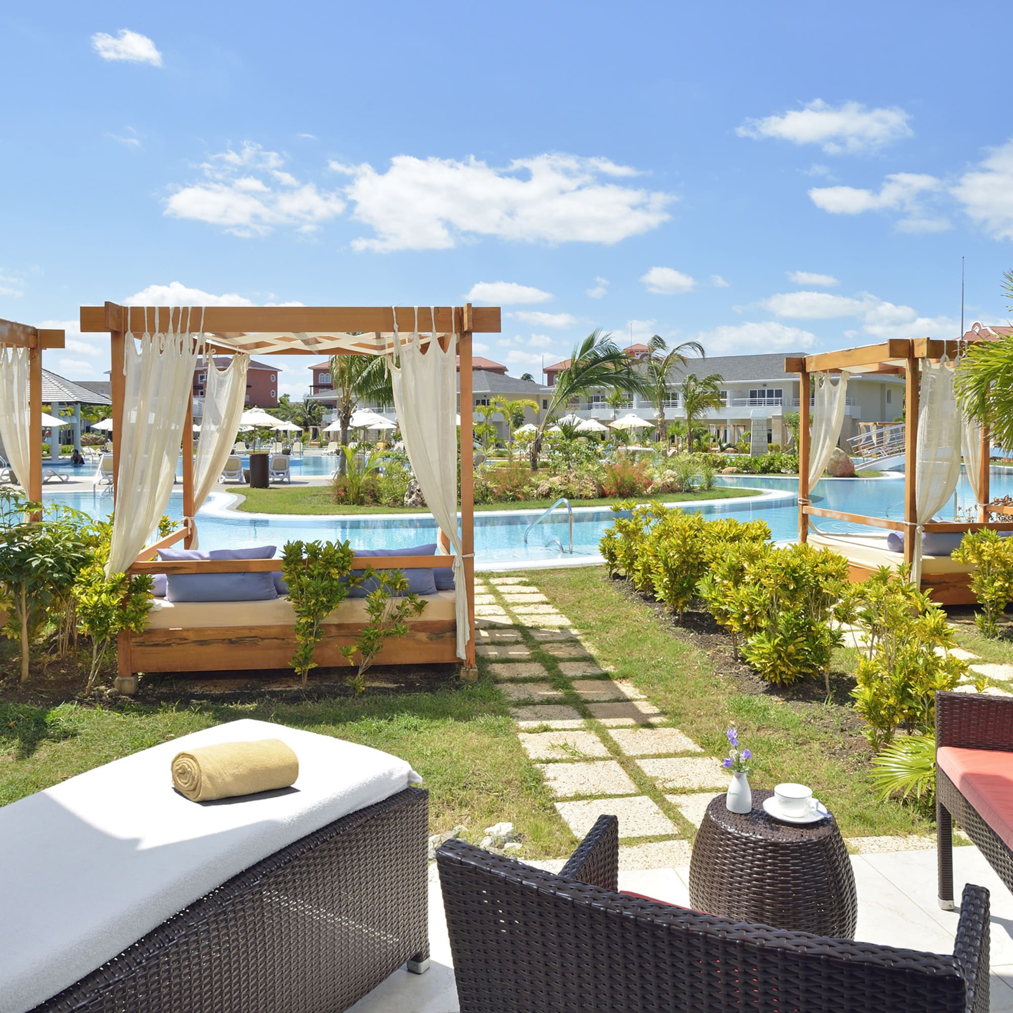 a pool with chairs and a bed